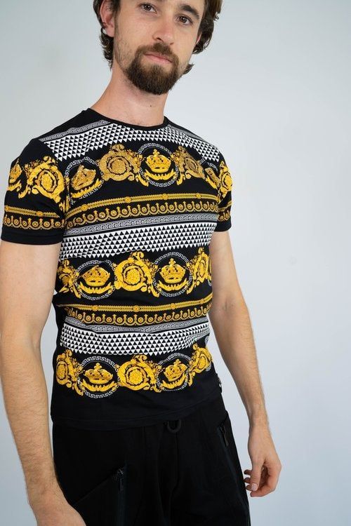 A man with a beard is wearing a black and gold striped t-shirt