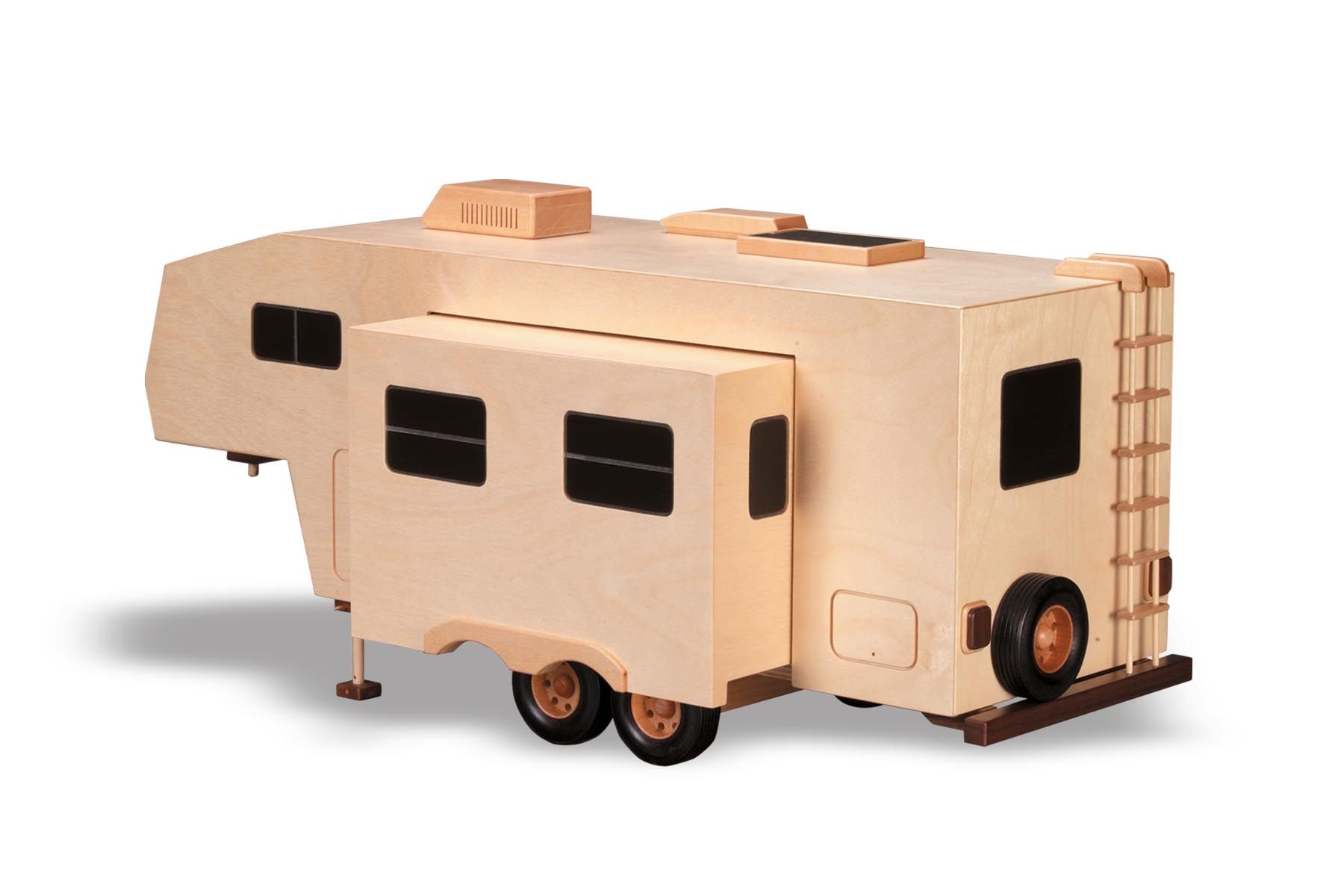 Wooden model of a fifth-wheel RV, tan with black windows, wheels, and ladder; the slide-out is extended.