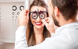 Doctor Checking Woman's Eye - LASIK Surgery in Saint Cloud, MN
