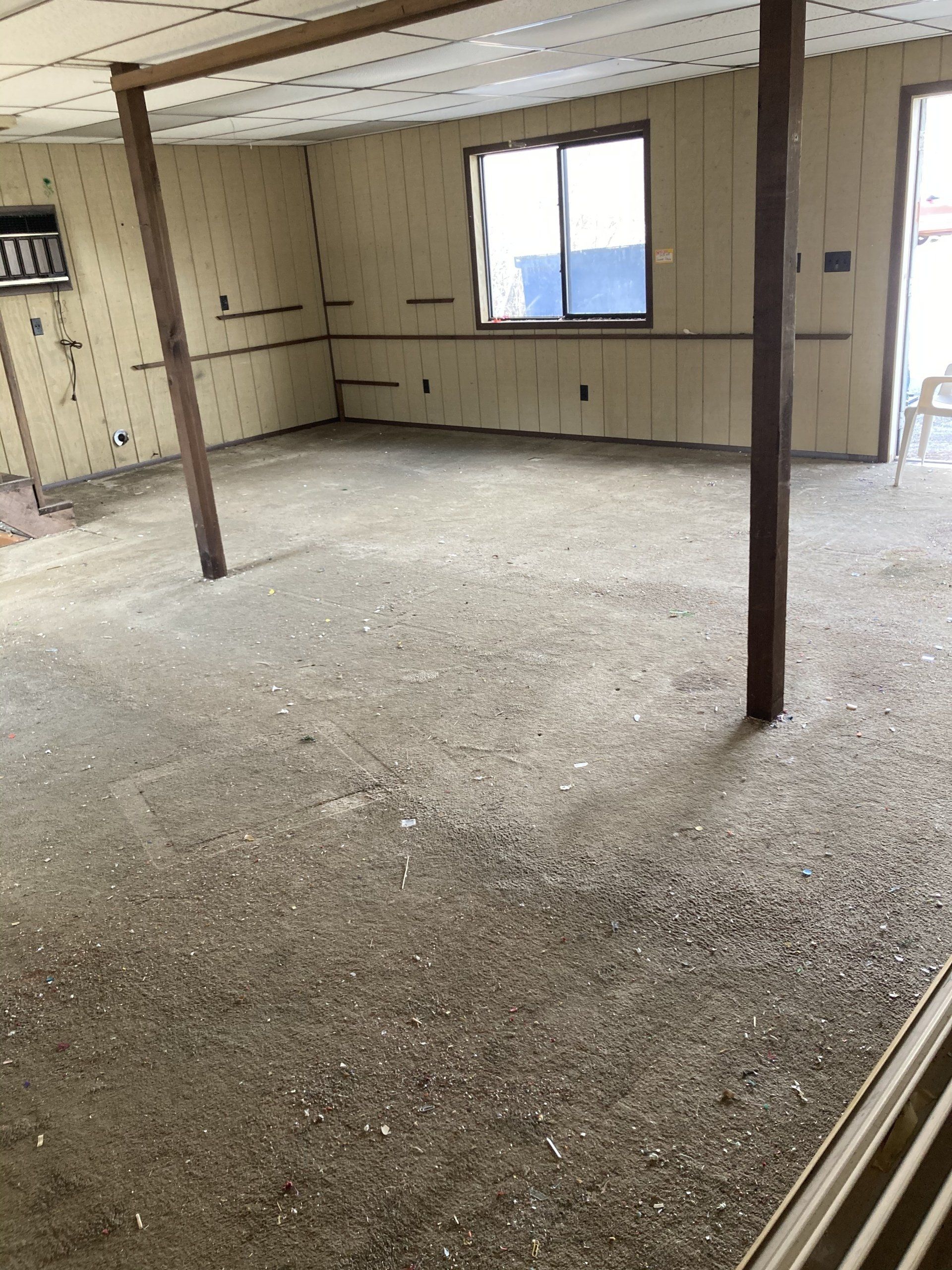 An empty room with a chair and a window