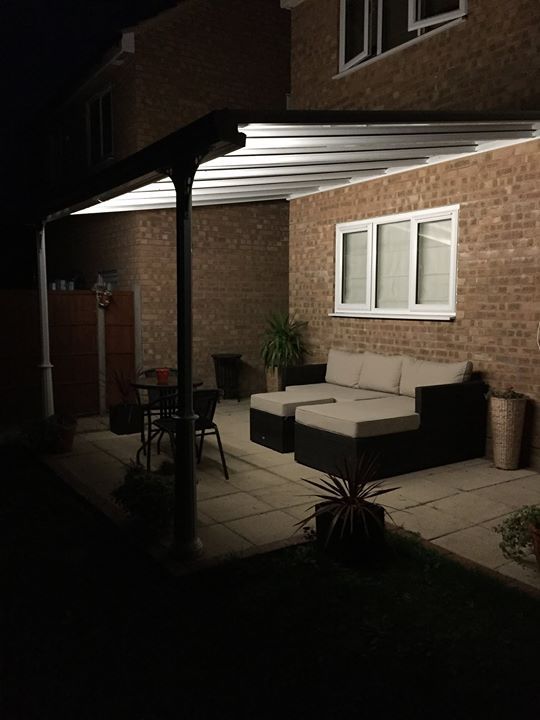 Glass veranda with led lighting over patio in Yorkshire with garden