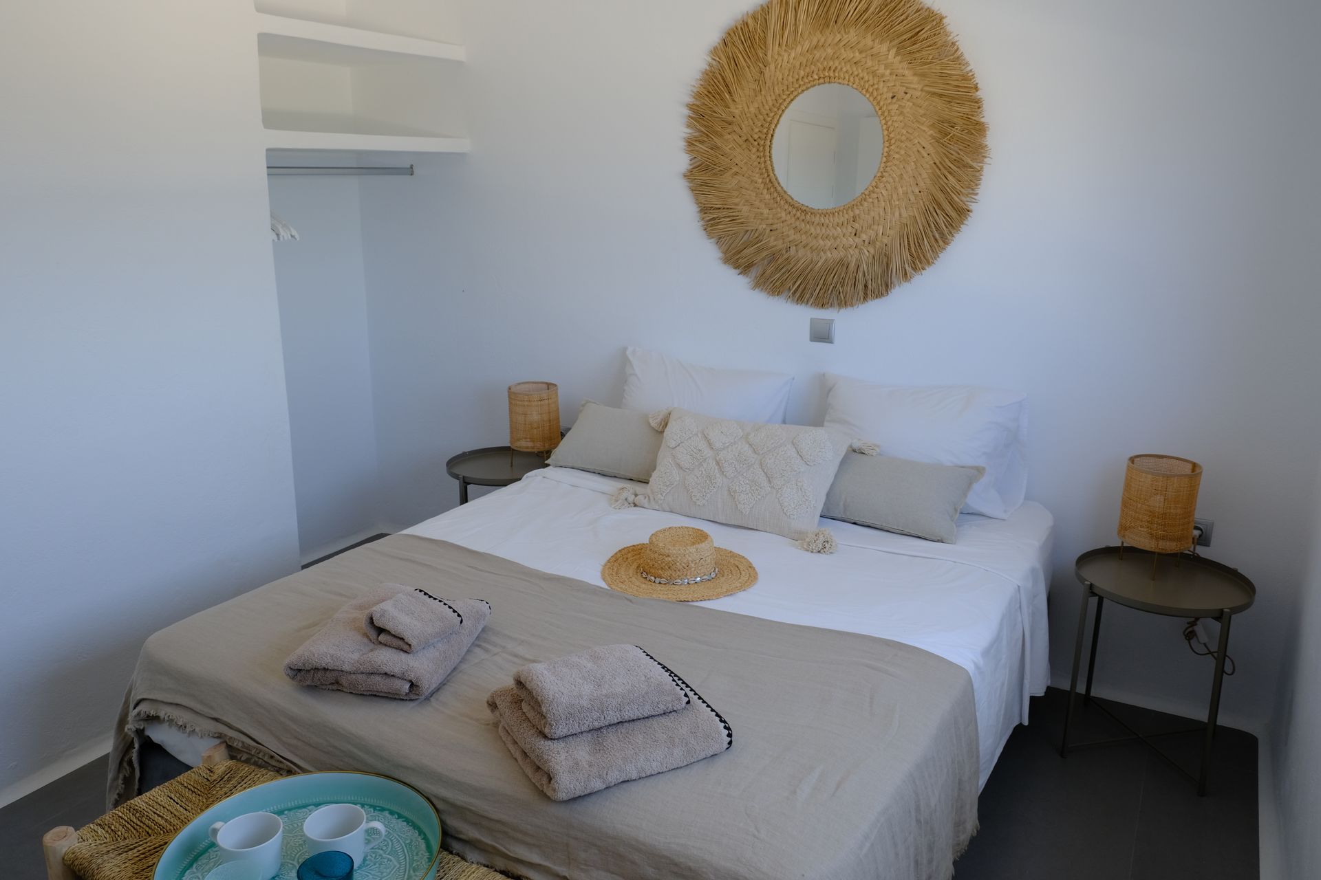 A bedroom with a bed and a mirror on the wall.