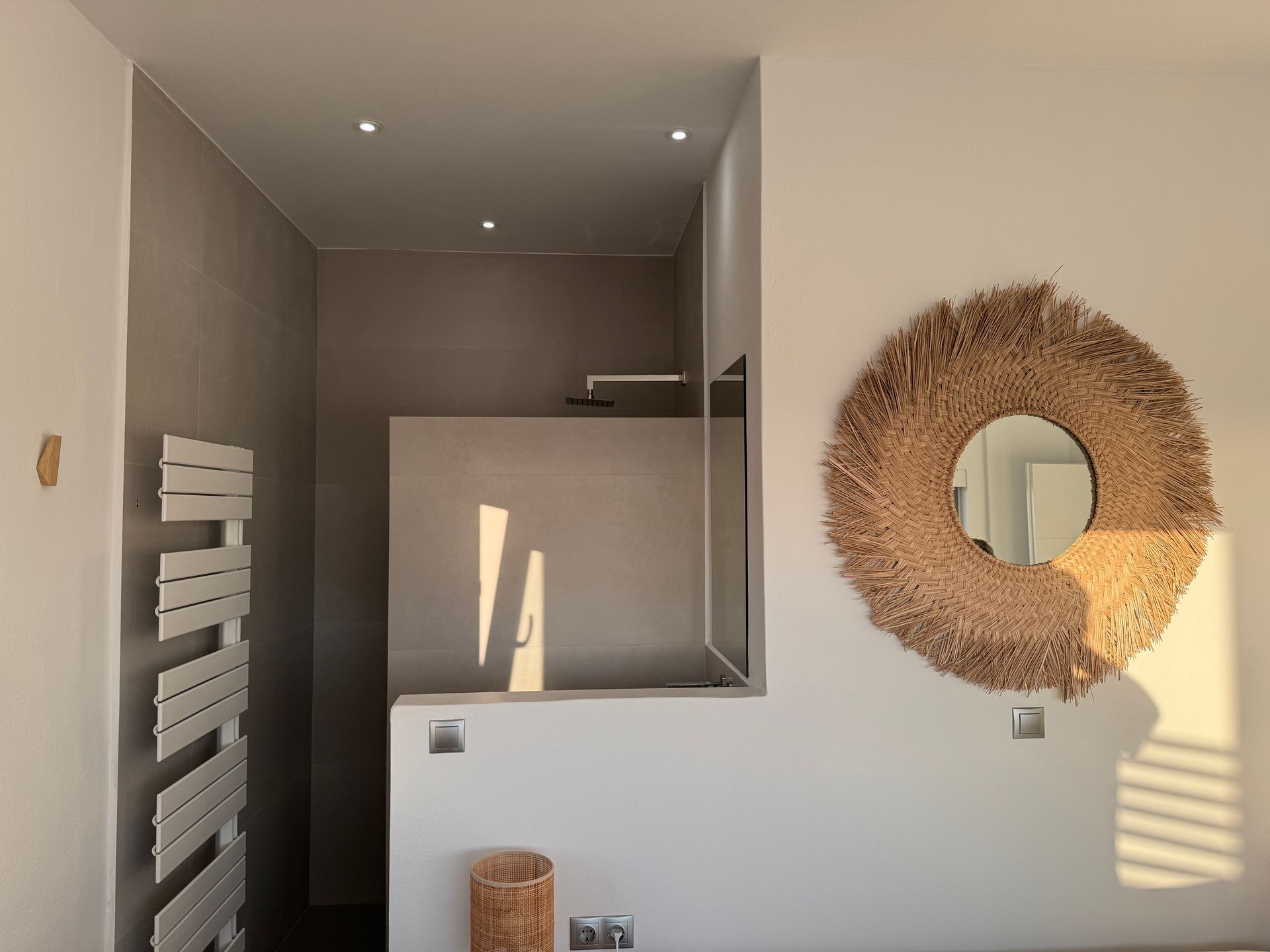 A bathroom with a mirror and a towel rack
