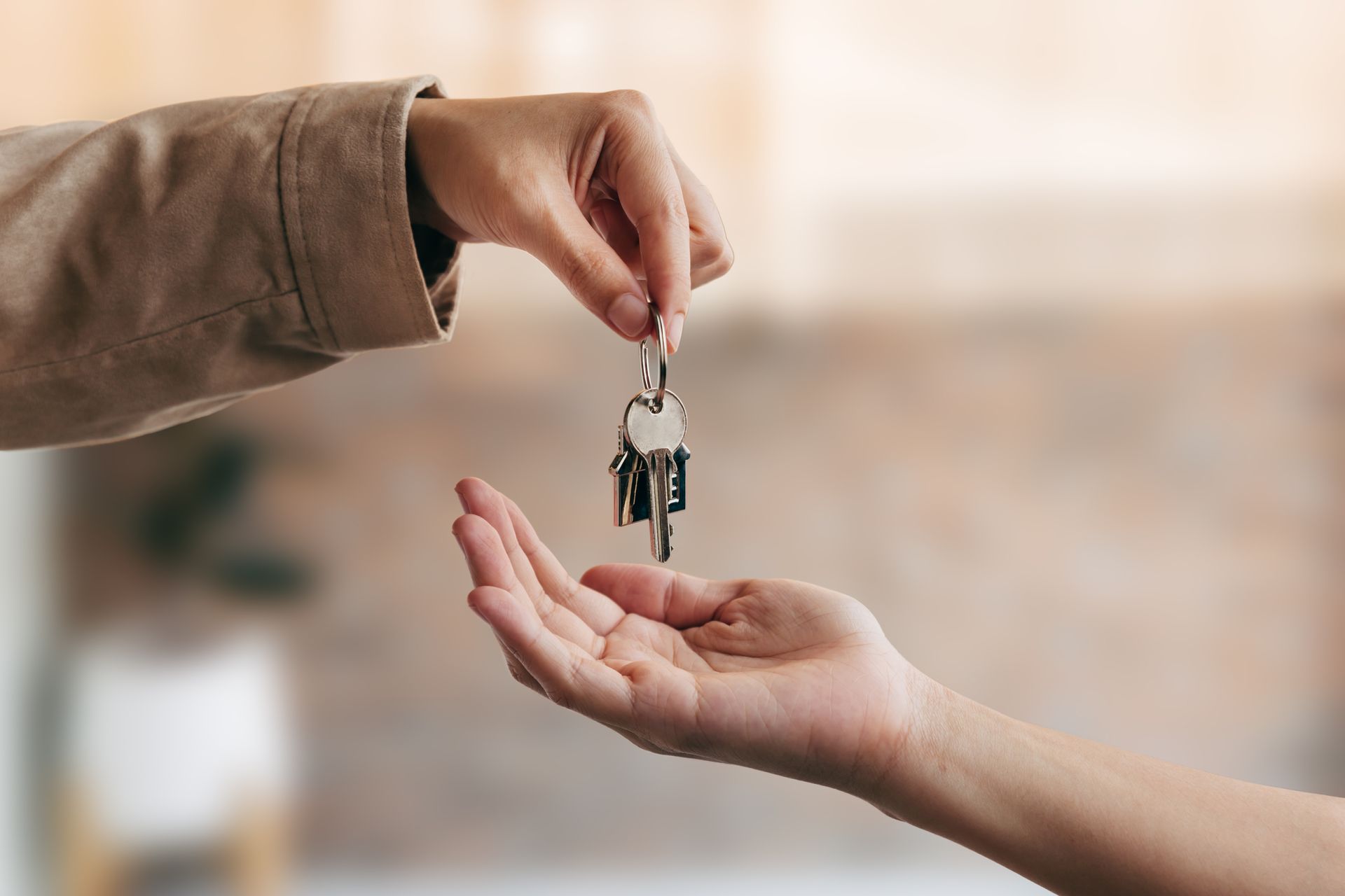 Hand passing keys to another hand.