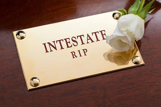 Gold plaque on dark wood reads 