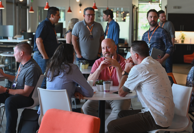 A group of people are sitting at tables in a room.