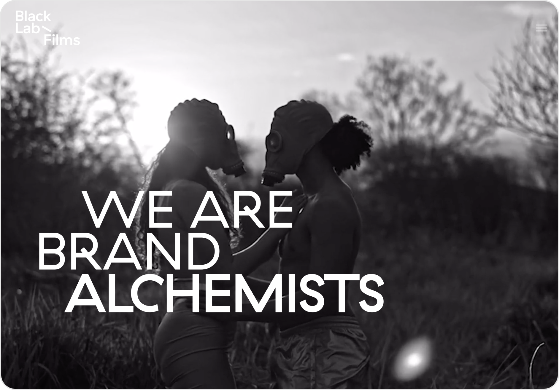 A black and white photo of two people with the words we are brand alchemists