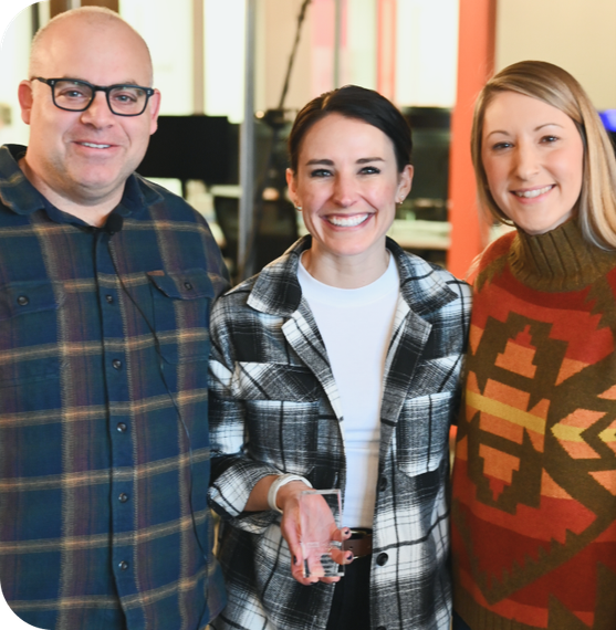 A man and two women are posing for a picture together