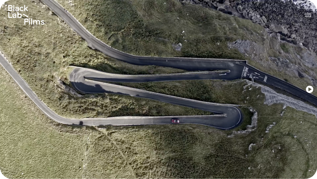 An aerial view of a winding road in the mountains.