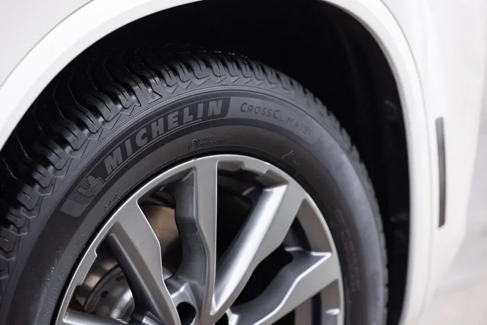 a close up of a michelin tire on a white car