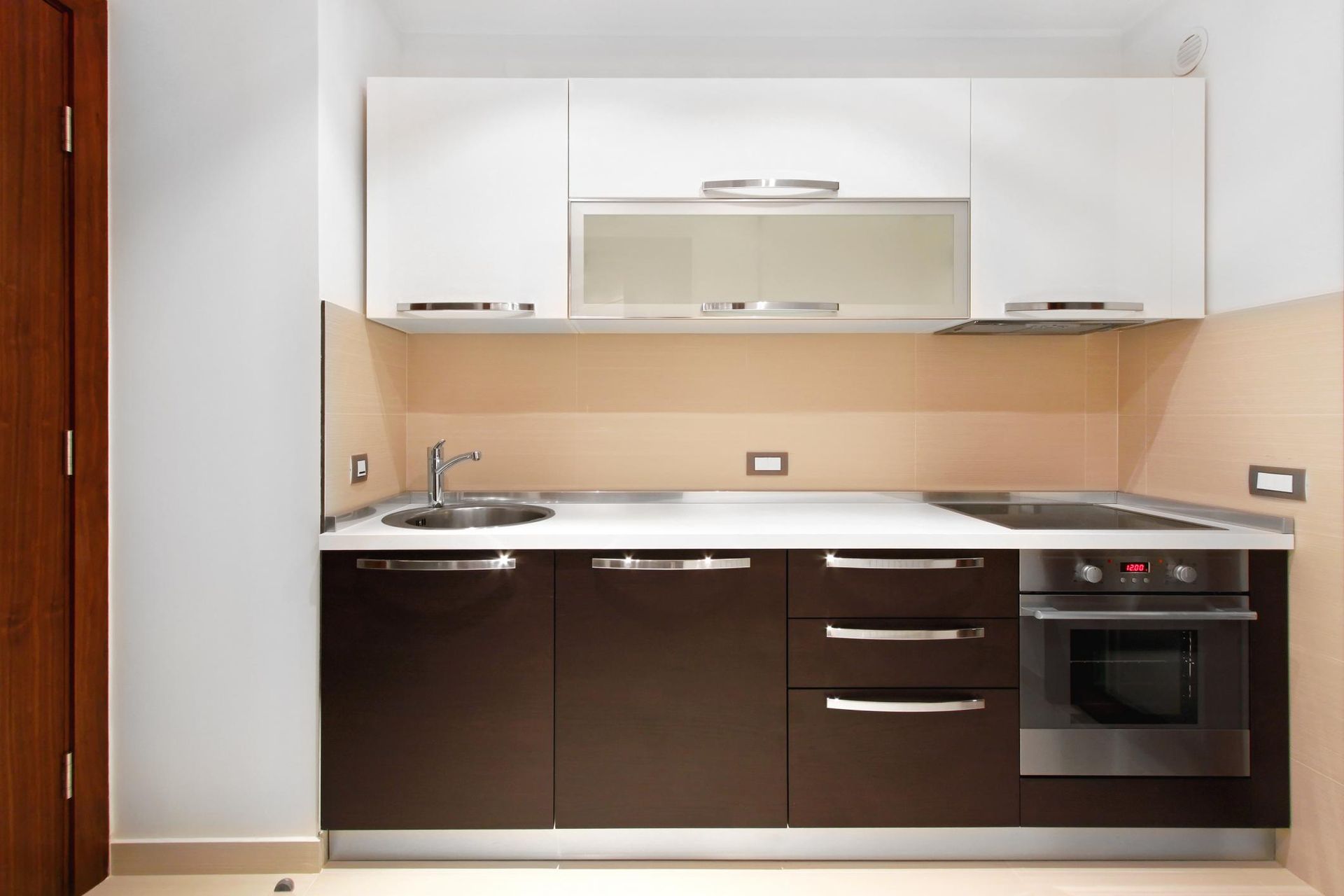a kitchen with brown cabinets and white cabinets and a stove