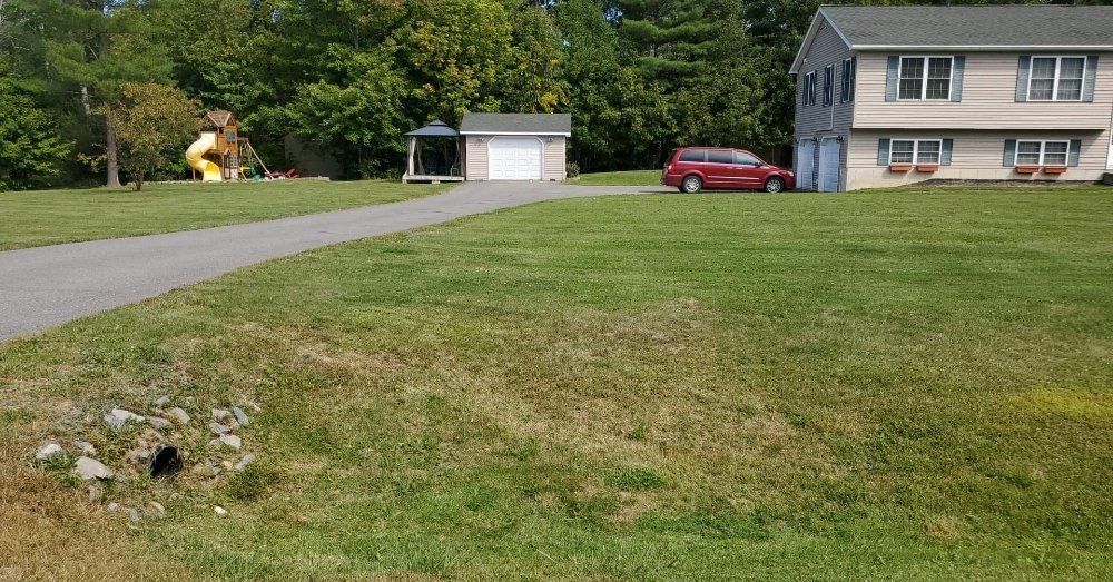 A house with a red van parked in front of it.