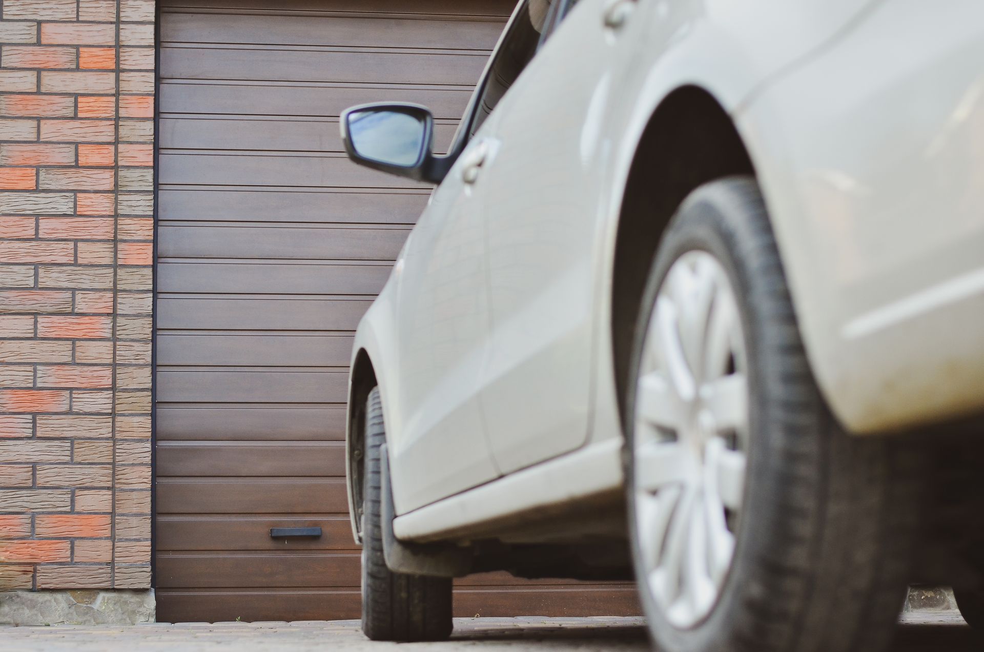 a car is parked in front of a garage door .