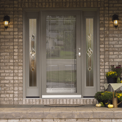 The front door of a brick house with a glass door
