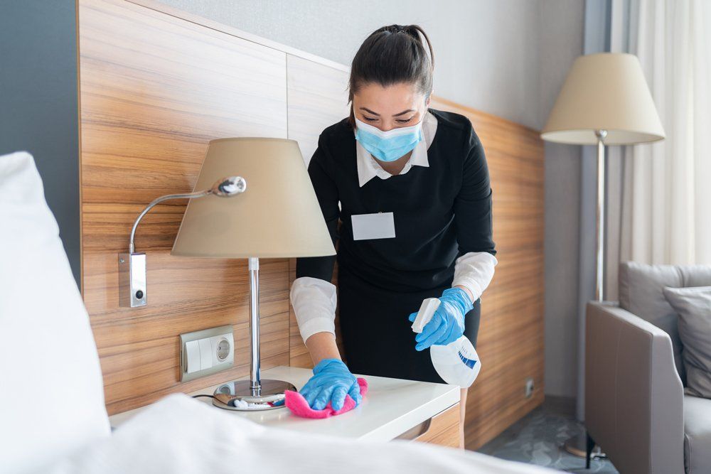 Female Worker Cleaning The Bedroom - Houston, TX - All Premiere Service Solutions