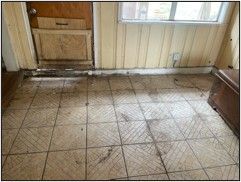 A room with a tiled floor and a door.