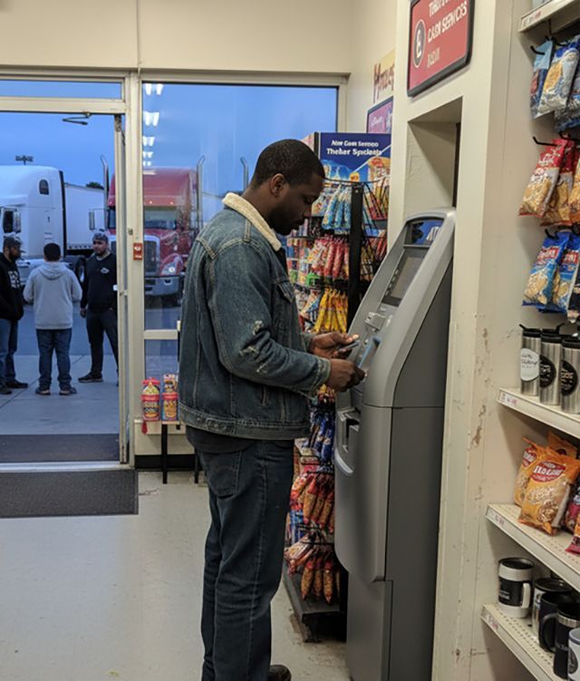 Customer withdrawing cash from a retail ATM at a O'Fallon, Missouri business.
