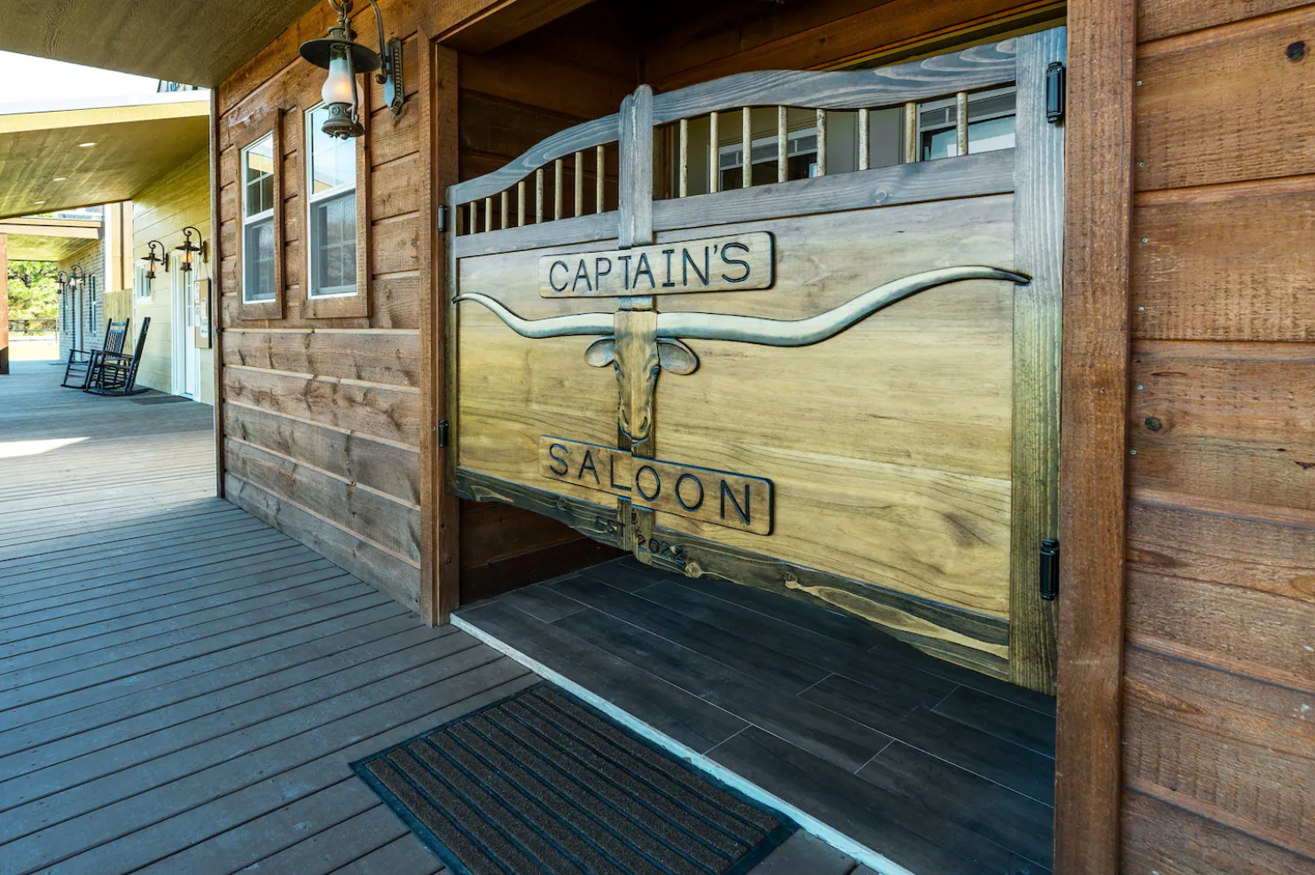 A wooden garage door with the words `` captains falconi '' written on it.