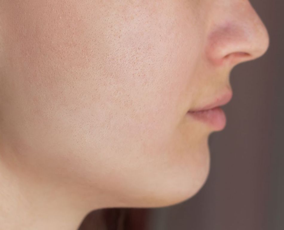 A close up of a woman 's face with no makeup on.