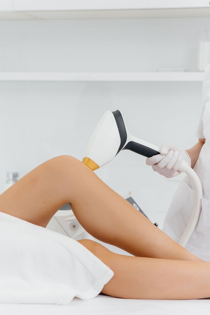 A woman is getting a laser hair removal treatment on her legs at iinSkin Clinic in Windsor UK