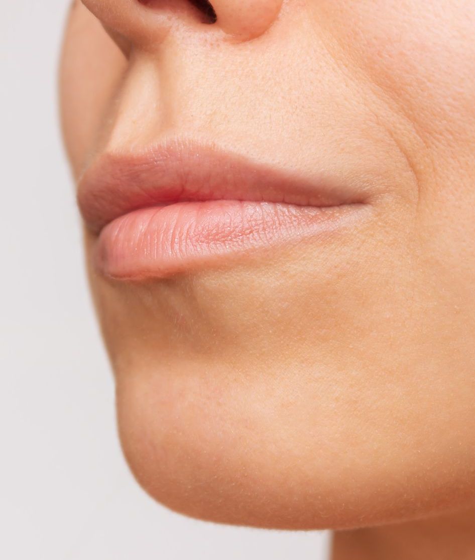 A close up of a woman 's face with her mouth open