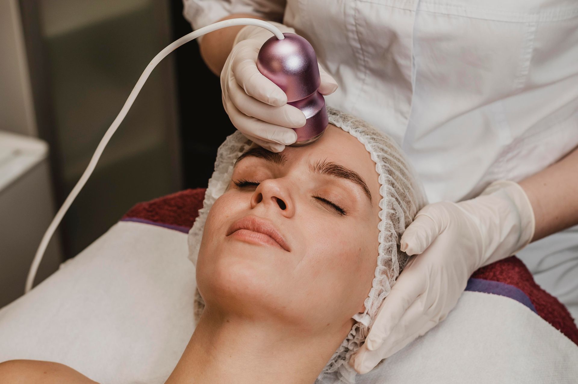 A woman is getting a facial treatment at a beauty salon