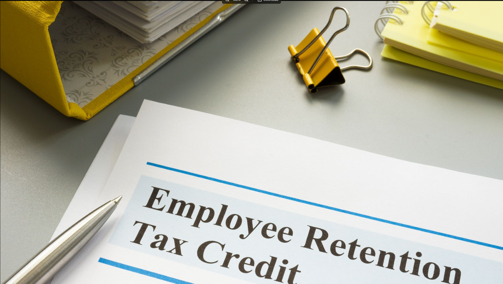 A pen is on a piece of paper that says employee retention tax credit