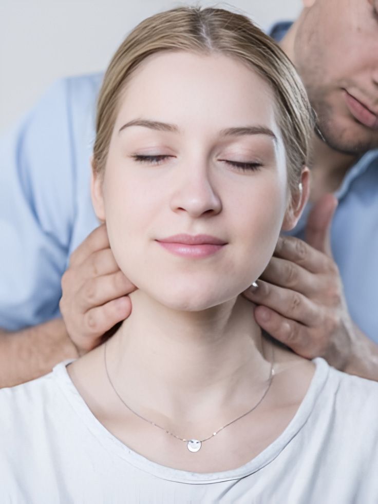 A Man Is Giving A Woman A Neck Massage With Her Eyes Closed — Back In Motion Chiropractic & Healthcare In Innisfail, QLD