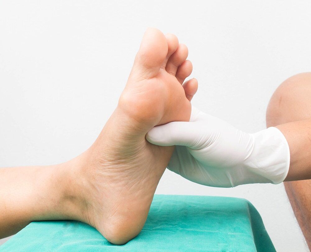 A Person is Getting Their Foot Examined by a Doctor — Back In Motion Chiropractic & Healthcare In Innisfail, QLD
