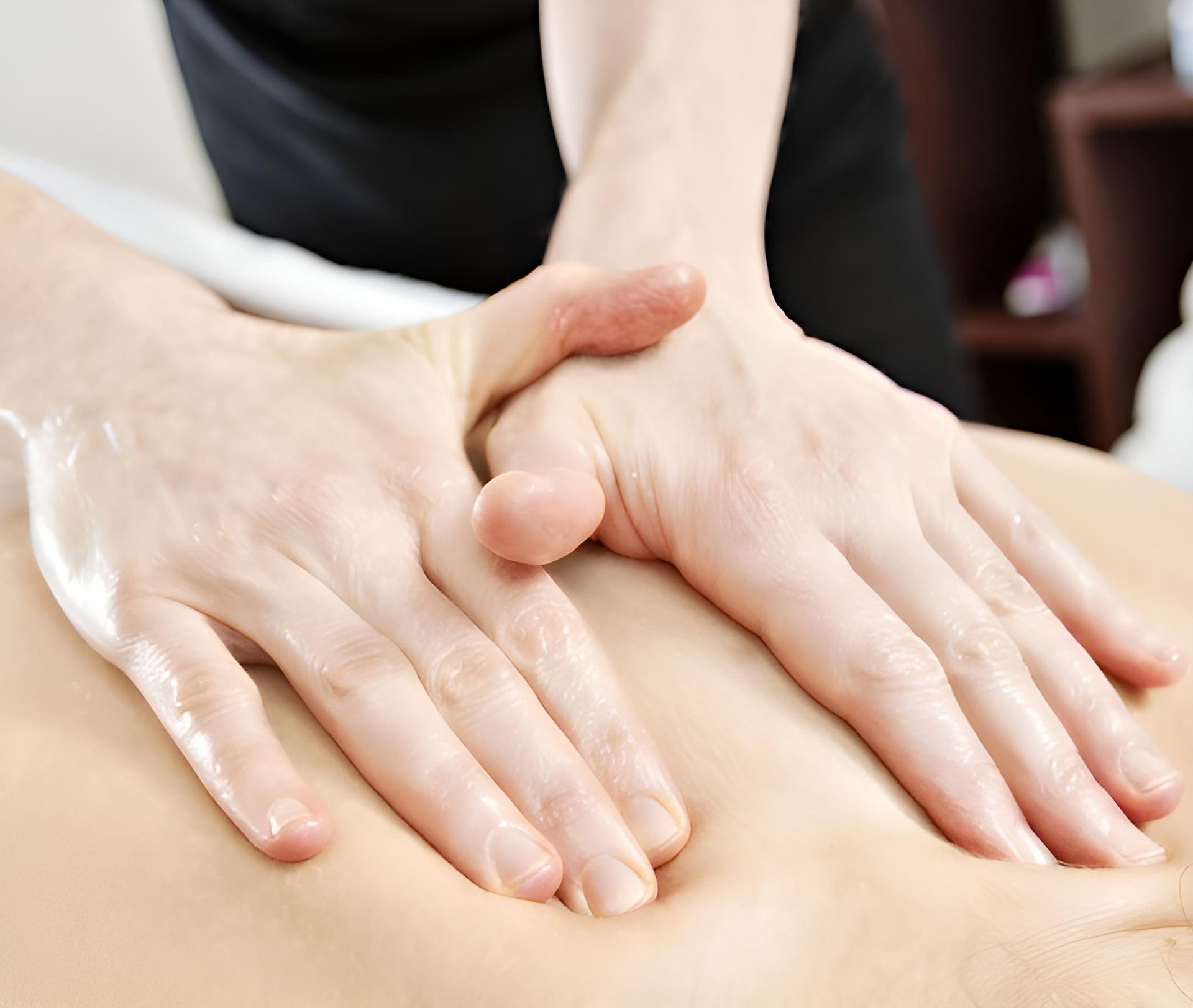 A Person is Getting a Massage With Their Hands on Their Back — Back In Motion Chiropractic & Healthcare In Innisfail, QLD