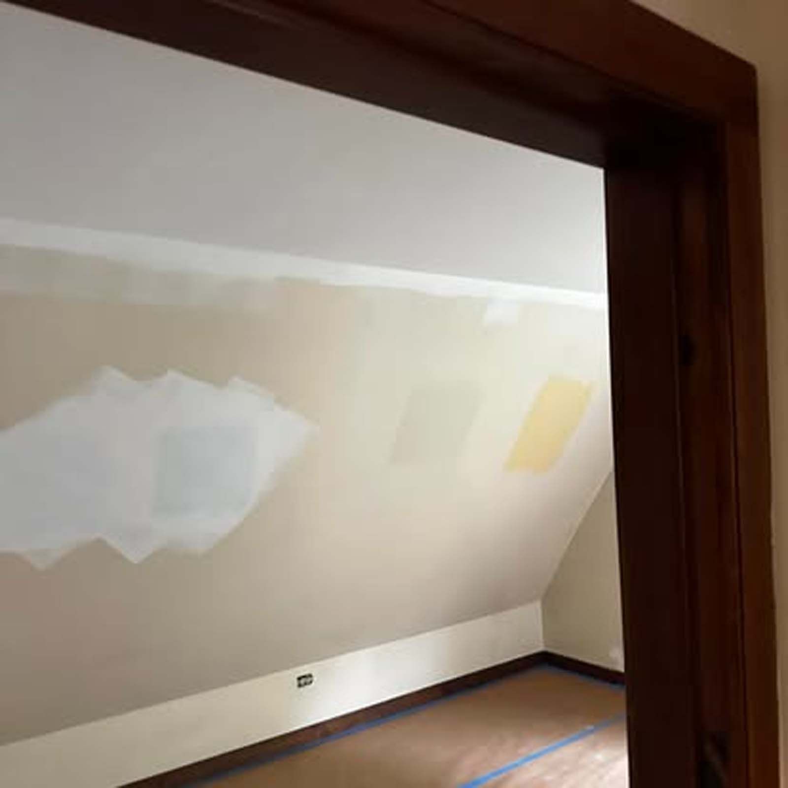 A room with a vaulted ceiling is being painted.