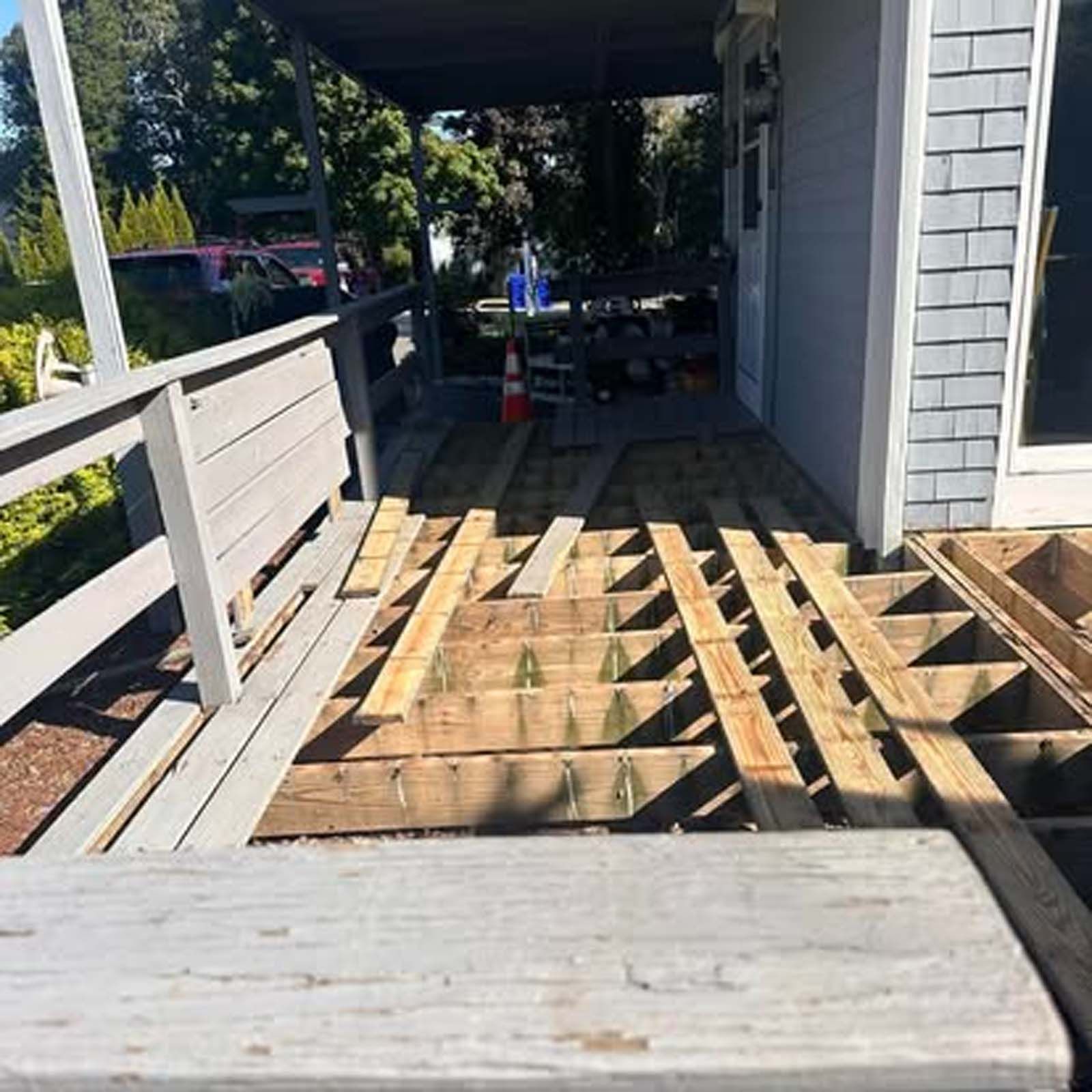 A wooden deck is being built on the side of a house.