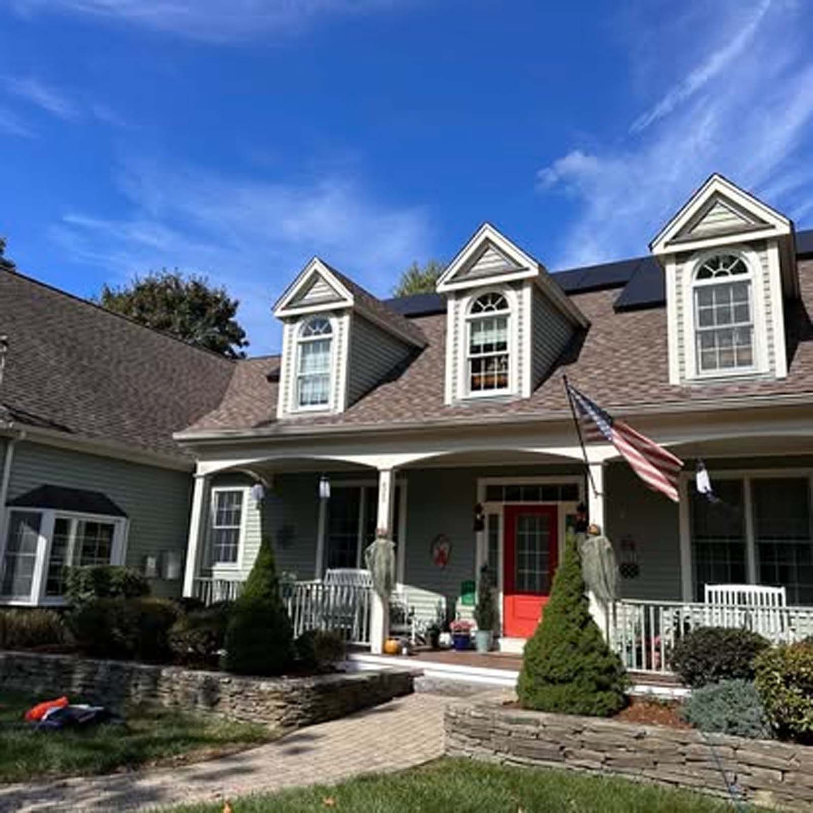 A house with a red door and an american flag
