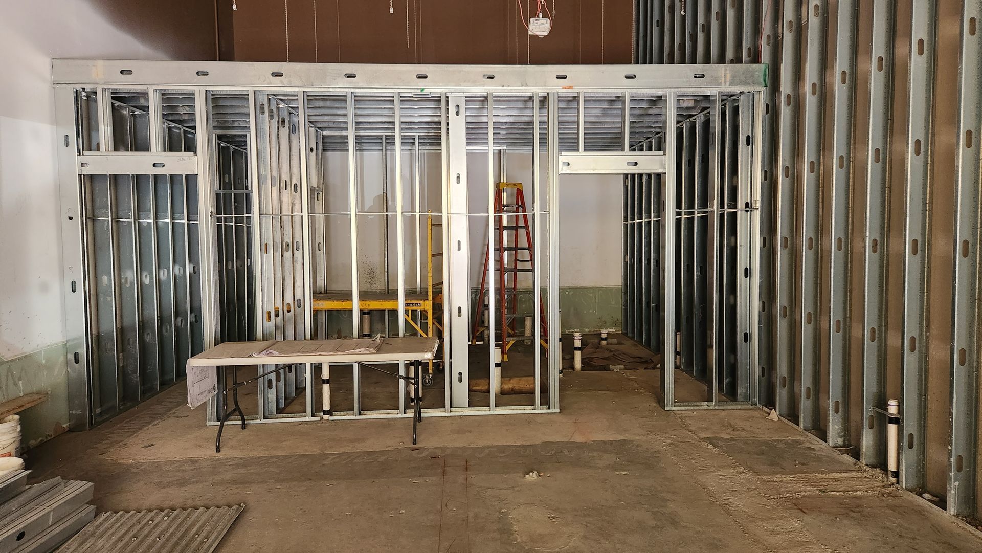 Interior of a building under construction. Steel framing for walls and doorways, unfinished.