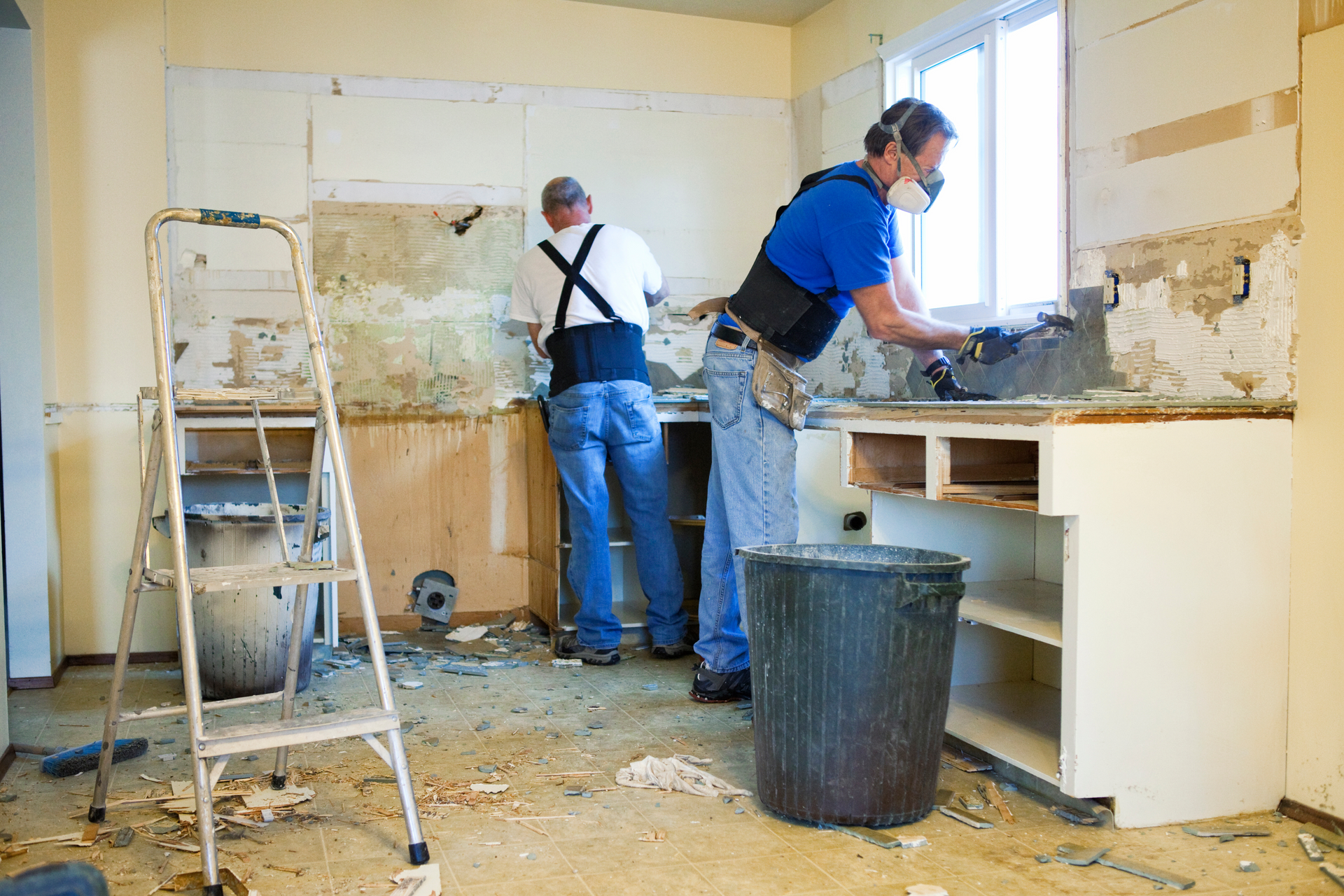 Home remodeling team performing kitchen demolition as part of a full interior renovation project.