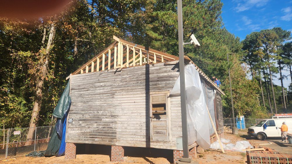 Ongoing custom home renovation with roof trusses and structural improvements in place.