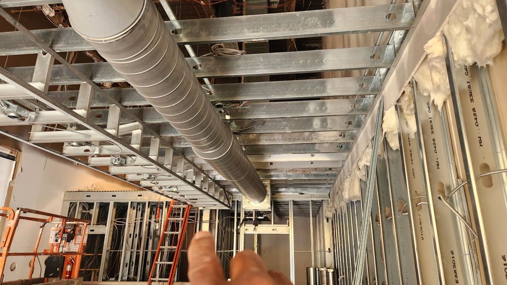 Commercial design build contractors installing HVAC ductwork and steel framing during tenant improvement.