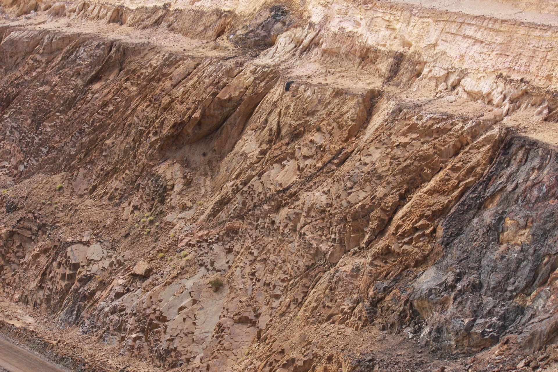 A large pile of dirt and rocks is sitting on top of a hill.