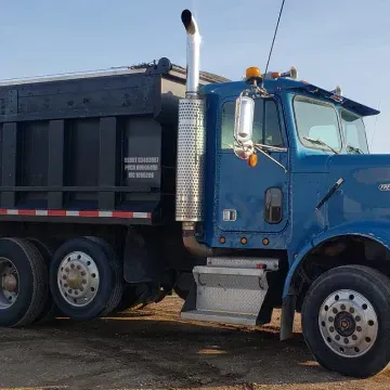 Blue dump truck with black bed, parked outdoors.