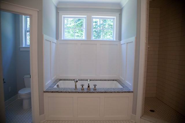 A bathroom with a jacuzzi tub and a toilet.