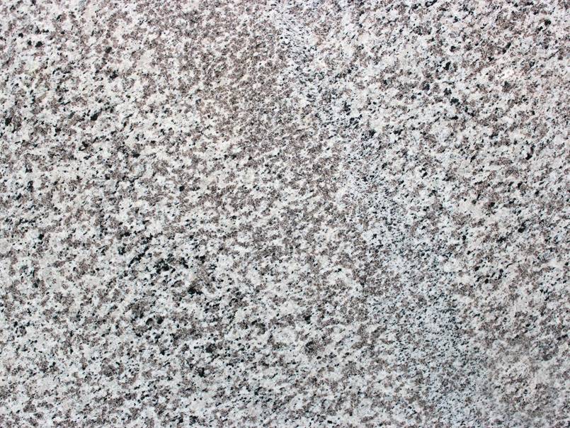 A close up of a gray granite counter top.