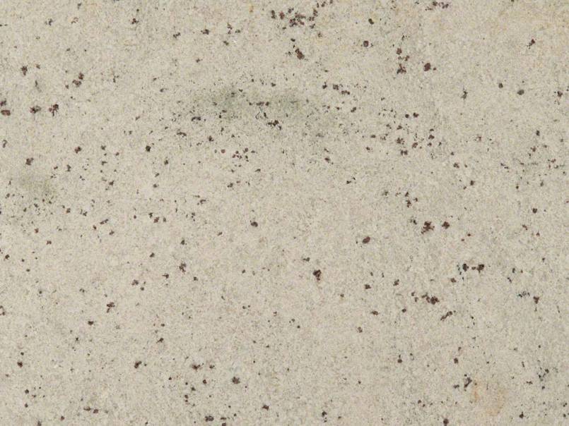 A close up of a white surface with black spots