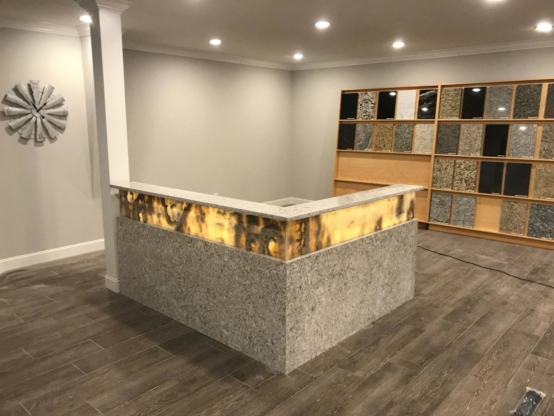 There is a clock on the wall above the counter in the room.