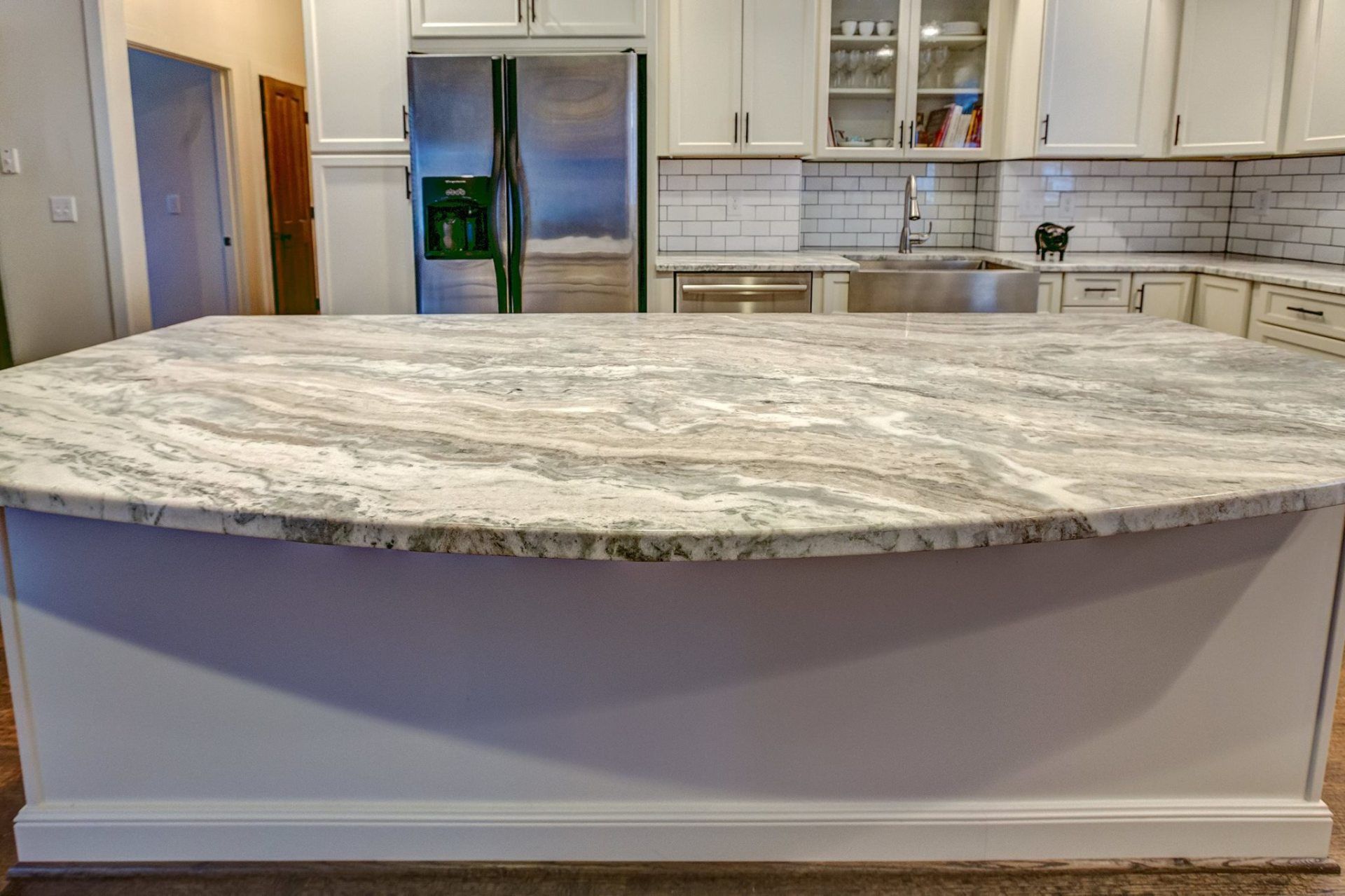 There is a large island in the middle of the kitchen.