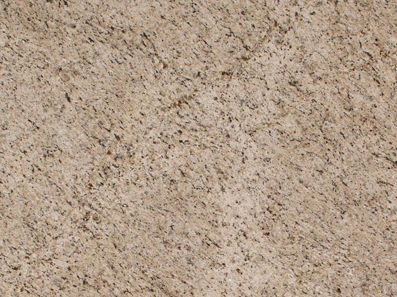 A close up of a beige granite counter top.