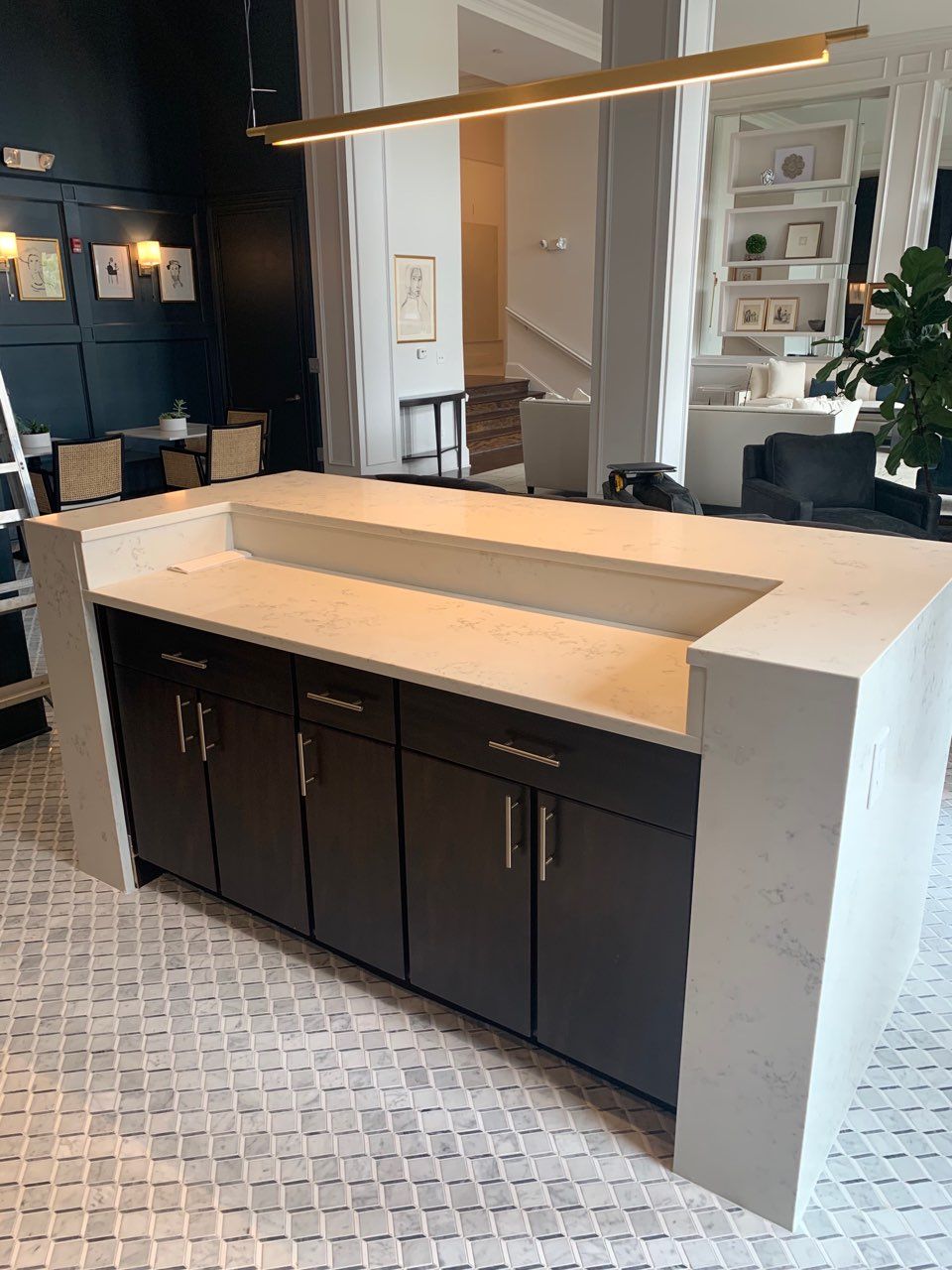 A kitchen with a large island and a sink in it.