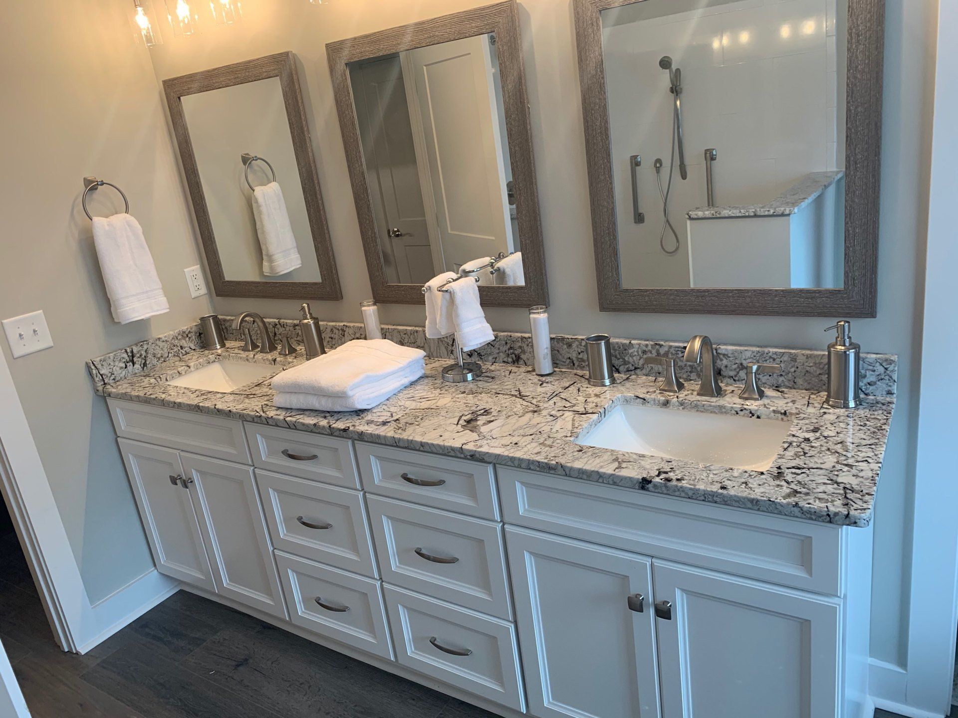 A bathroom with two sinks and two mirrors.