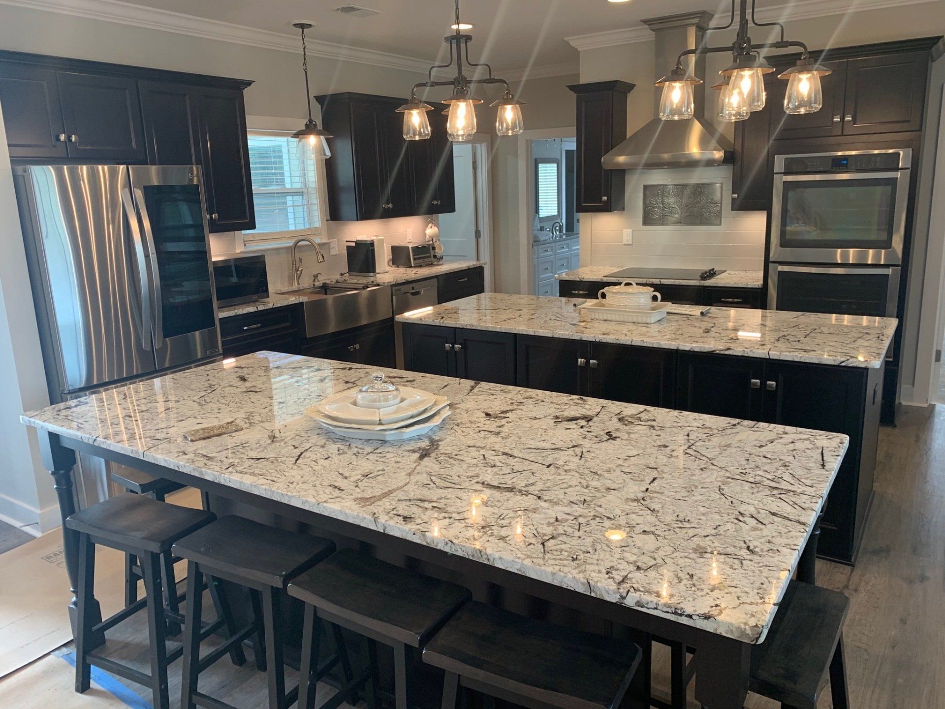 A kitchen with granite counter tops and stainless steel appliances