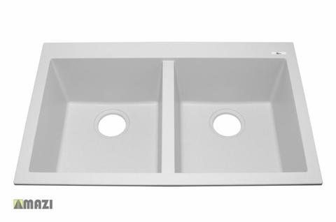 A white kitchen sink with two drain holes on a white background.