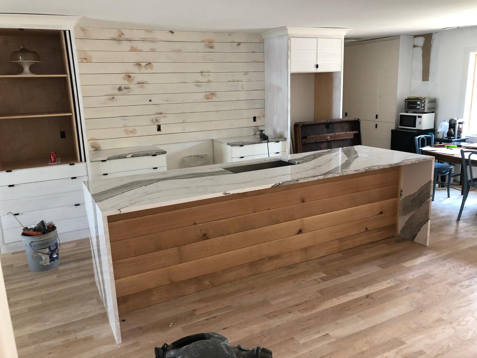 A kitchen with a large island in the middle of the room.
